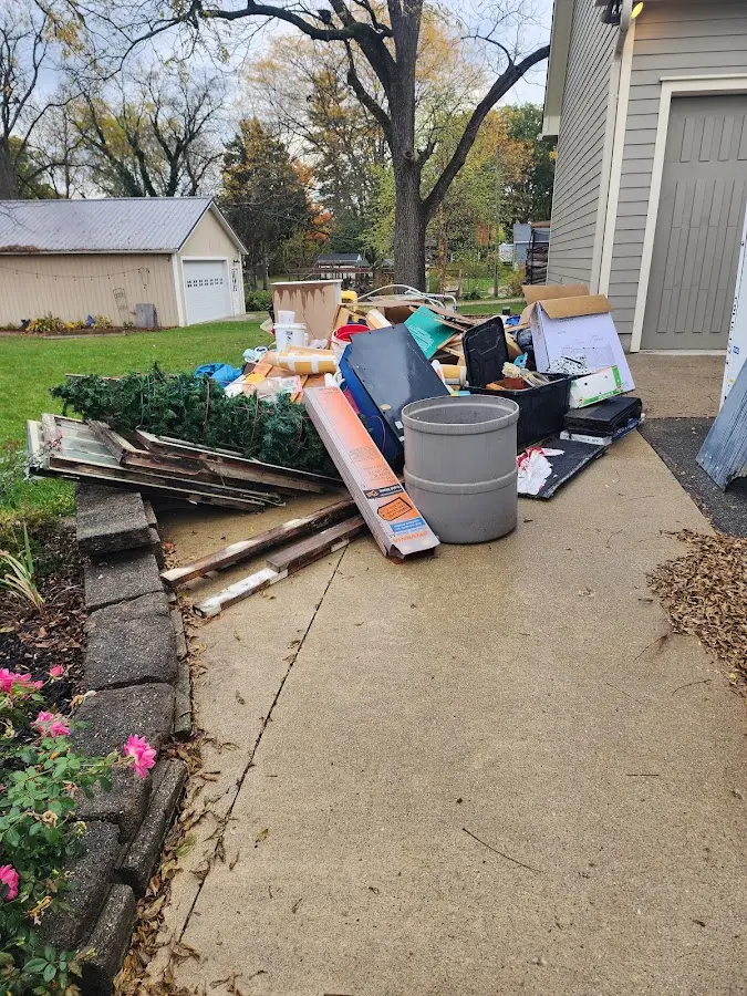 Dumpster being loaded with debris for Roofing Dumpster Rental in Red Oak